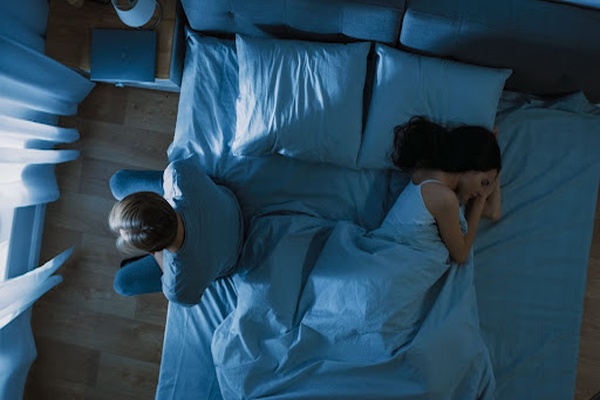 Couple in bed not speaking Couple in bed not speaking