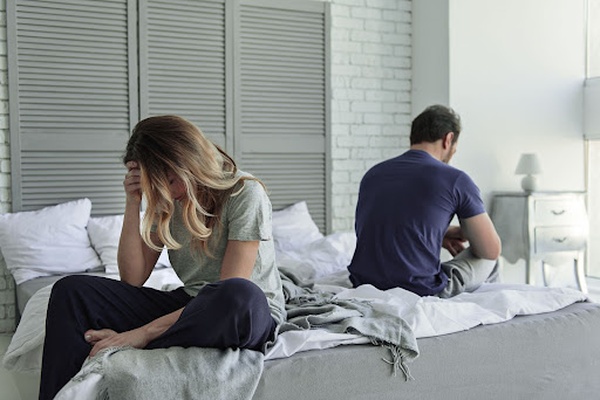 Frustrated couple sitting in bed Frustrated couple sitting in bed