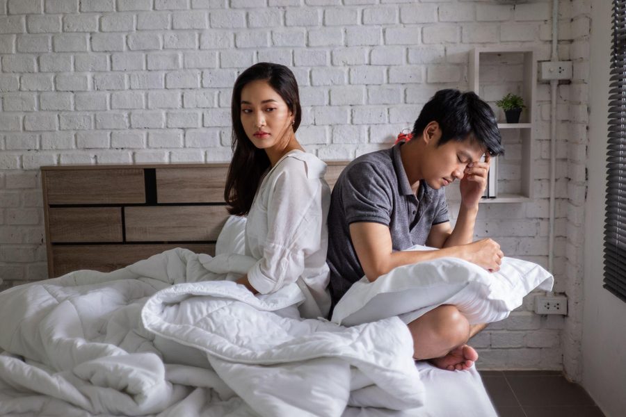 Frustrated couple in bed