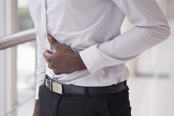 Man in pain holding his stomach Man in pain holding his stomach