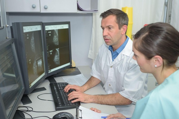 Doctors looking at computer screen Doctors looking at computer screen