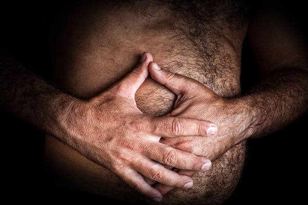 Man holding his stomach Man holding his stomach