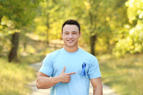 Young man with cancer awareness ribbon Young man with cancer awareness ribbon