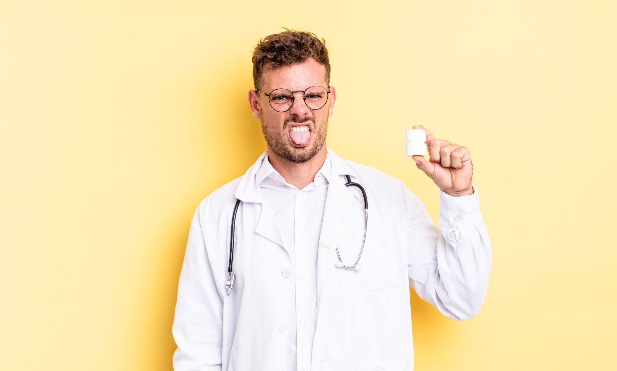 Disgusted doctor holding a pill bottle