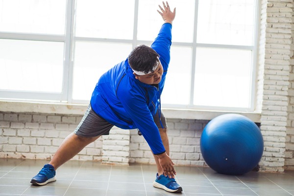 An overweight man exercising An overweight man exercising