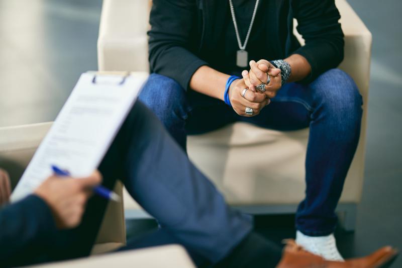 Man talking to a counselor Man talking to a counselor