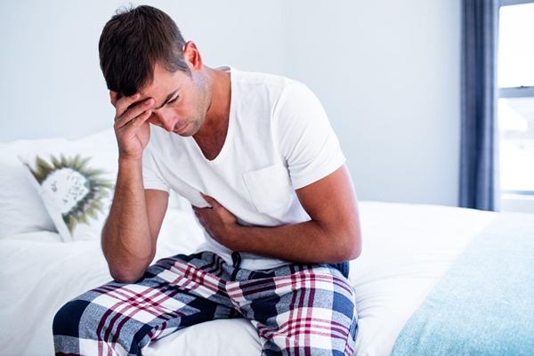 Man in pain sitting on the bed Man in pain sitting on the bed