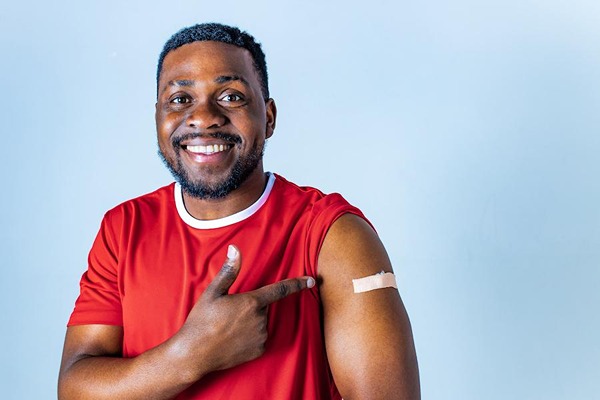 Man with a Band-Aid smiling Man with a Band-Aid smiling