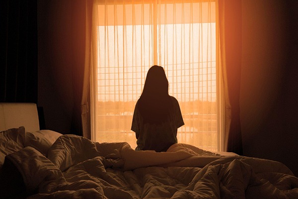 Woman sitting on the bed Woman sitting on the bed