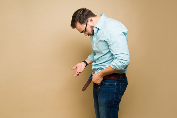 Man looking at his crotch with disappointment Man looking at his crotch with disappointment