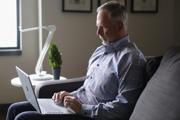 Man typing on a laptop Man typing on a laptop