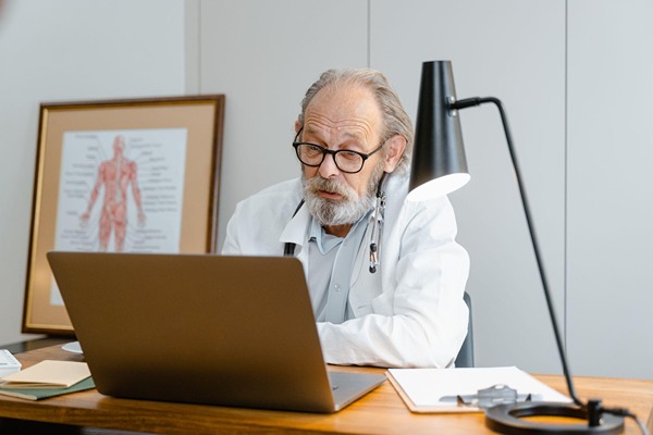 Doctor typing on a laptop Doctor typing on a laptop