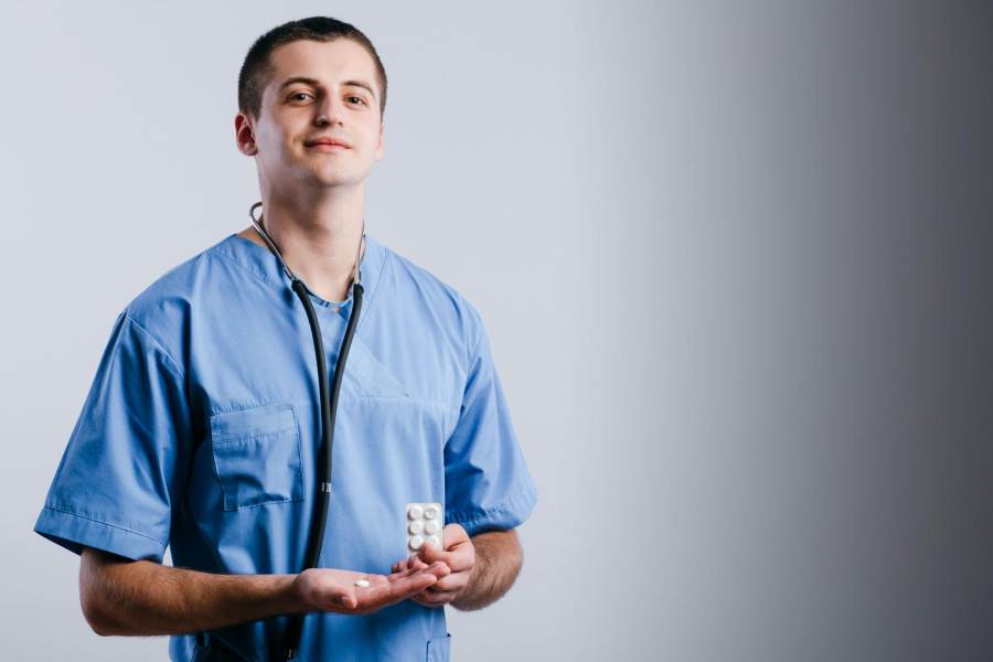 medical doctor holding a pill packet