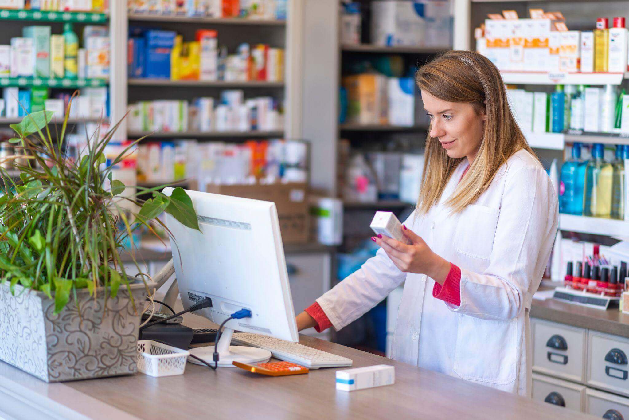 pharmacist checking product on the computer