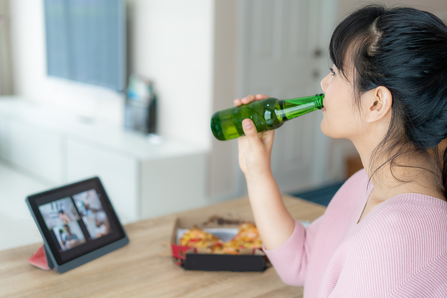 woman drinking beer at home
