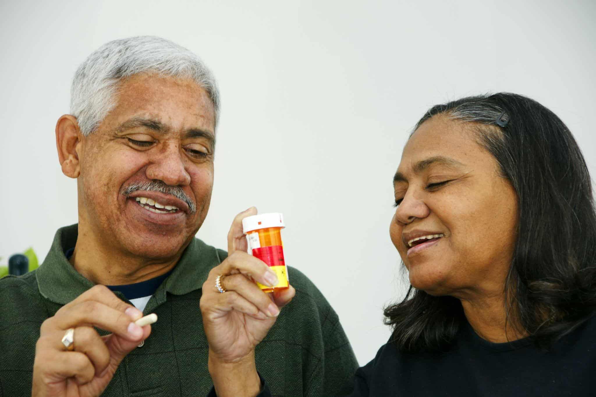 older couple holding a pill bottle