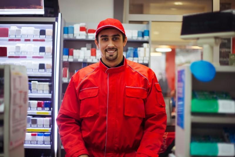 man smiling at a drugstore