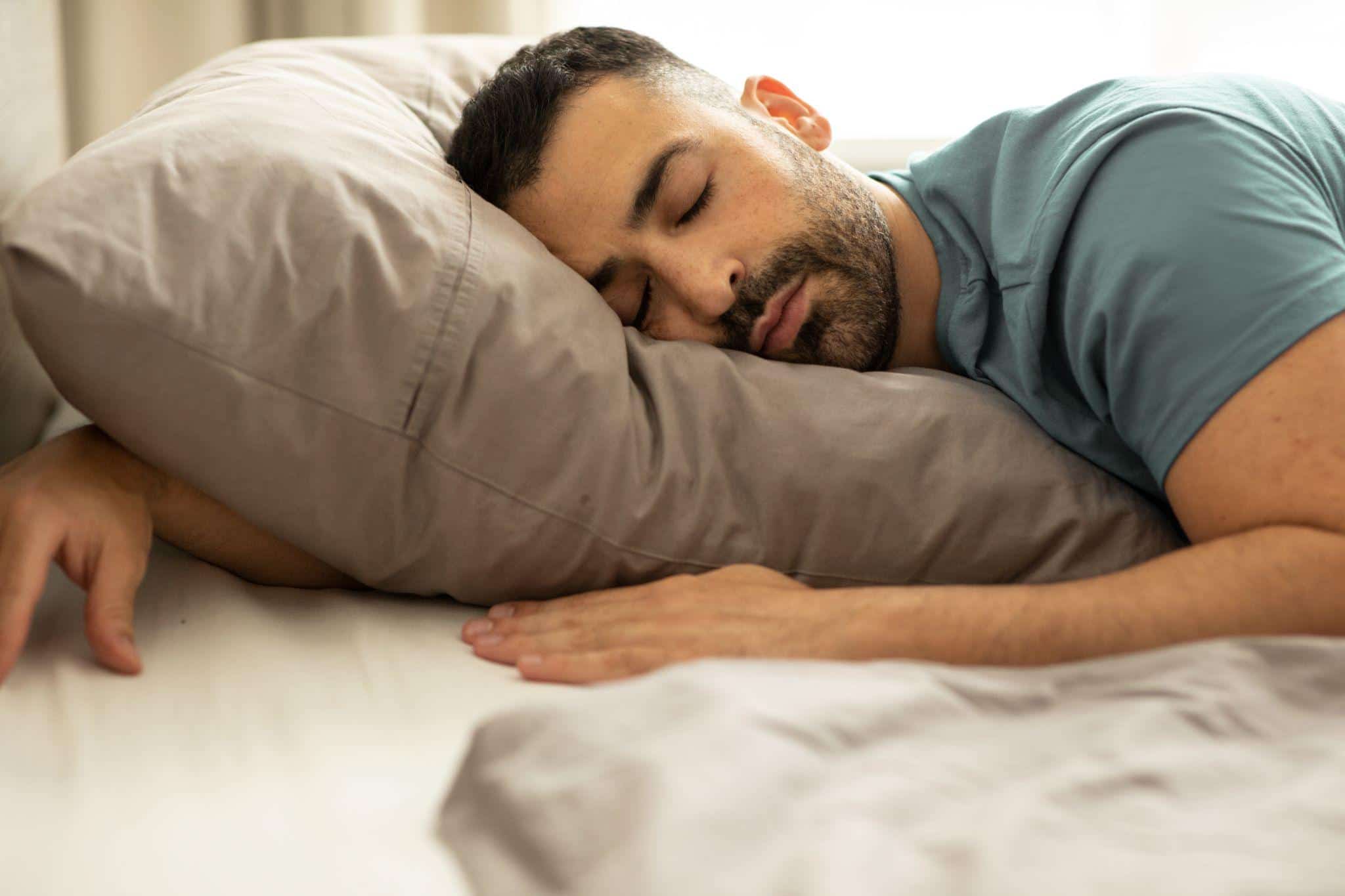 man sleeping in bed