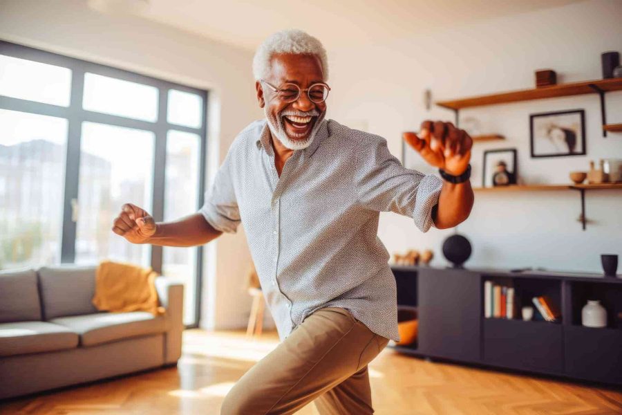 elderly man happily dancing in his living room