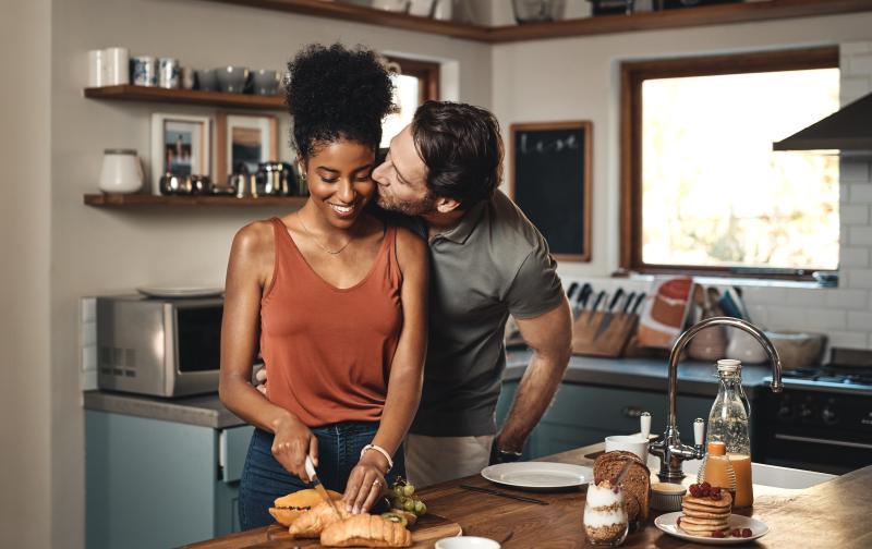 couple cooking and showing affection to each other