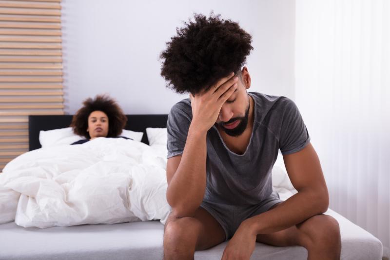 young man experiencing dizziness the edge of the bed