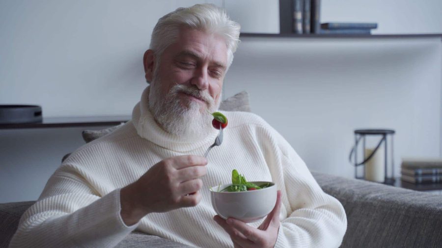 older man eating a salad