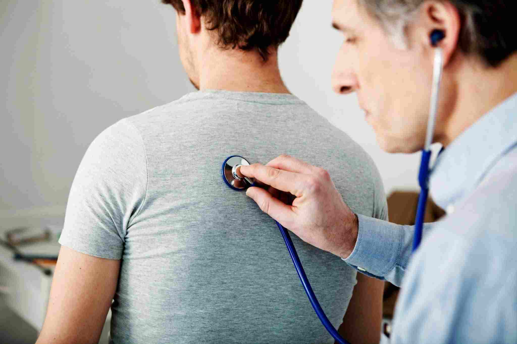 doctor checking a patient's lungs
