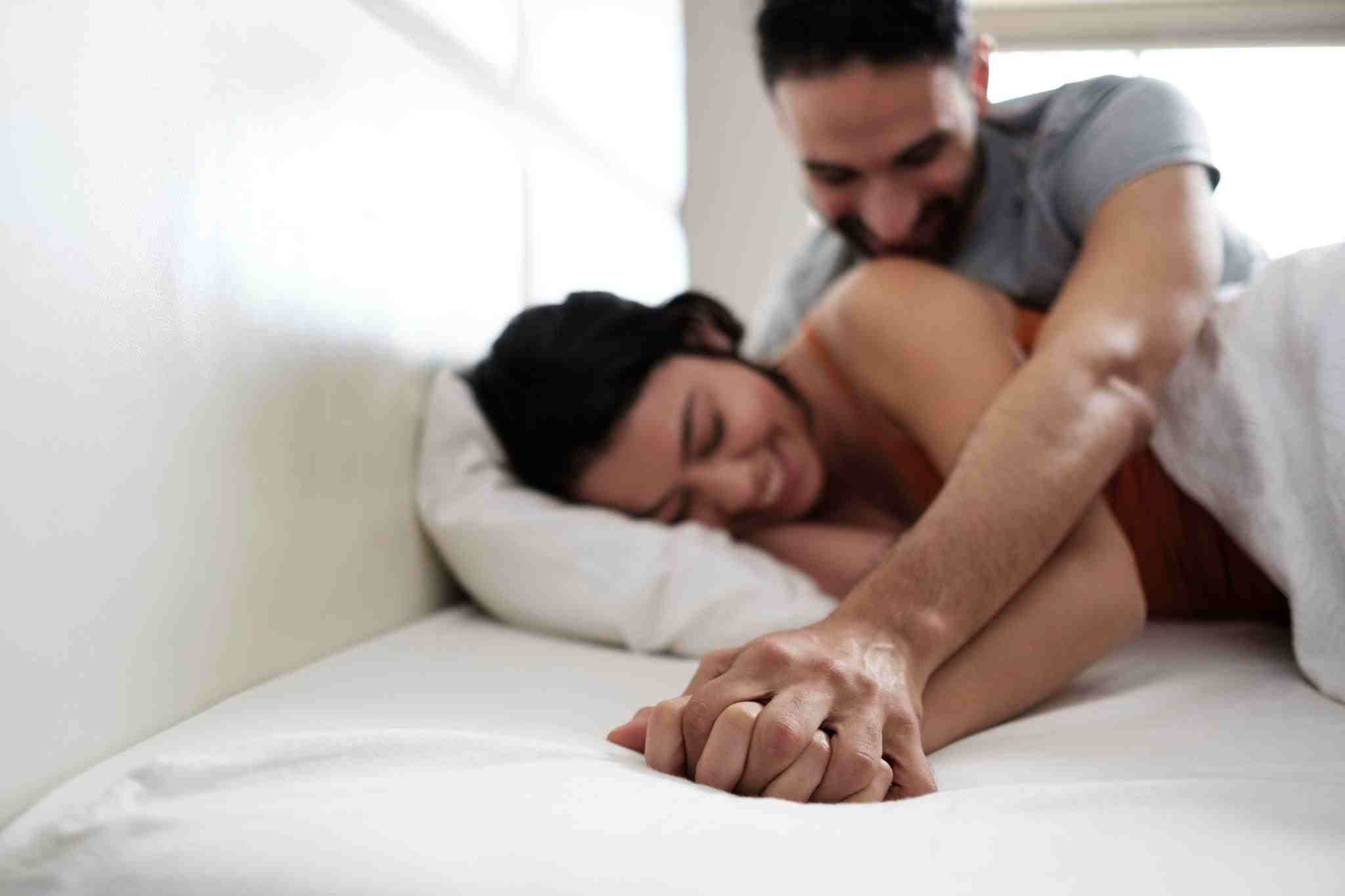 happy young couple in bed