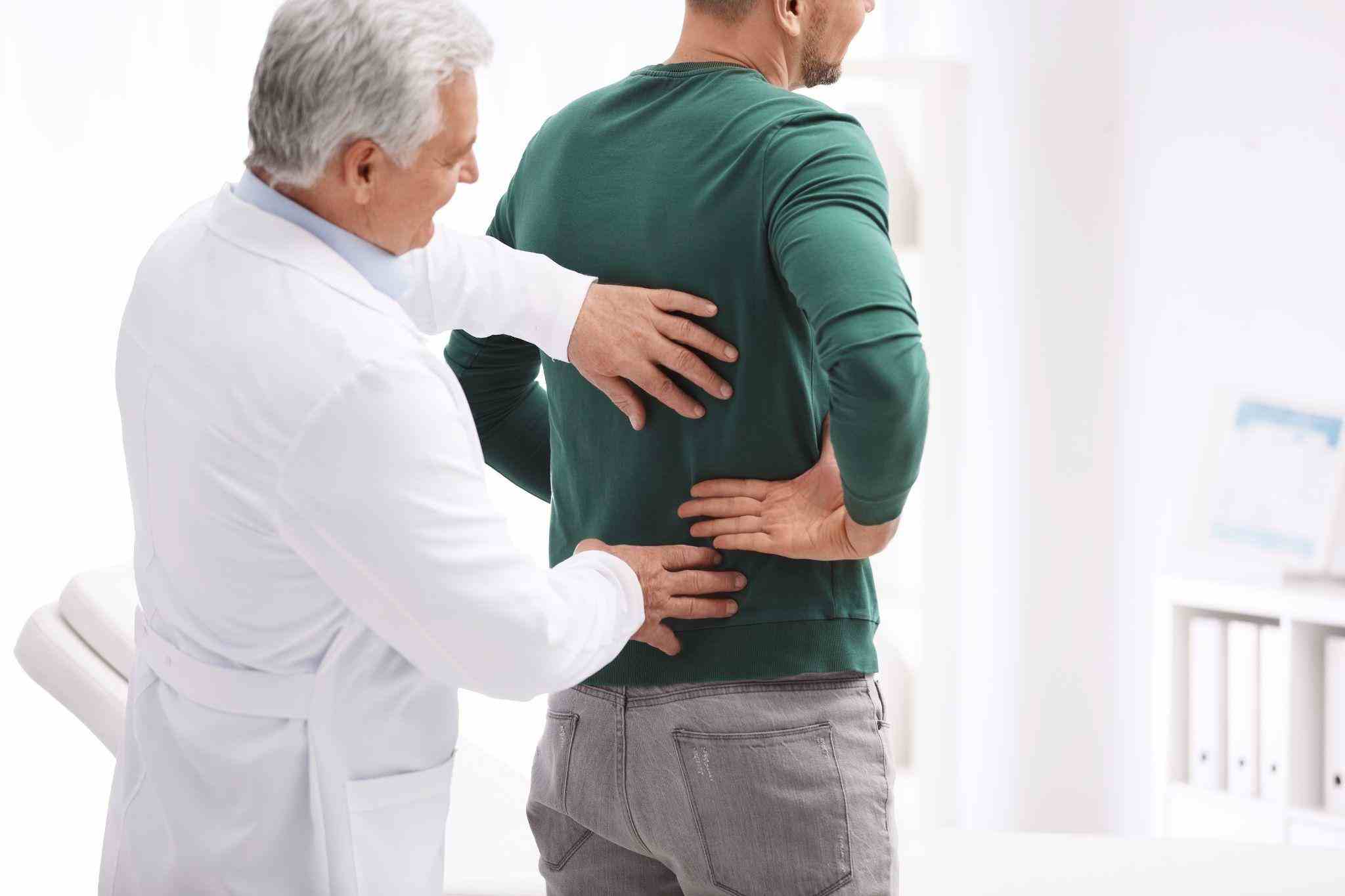 man at the doctor's due to muscle pain