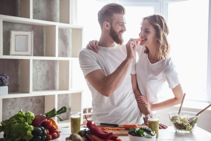 young couple cooking happily at home
