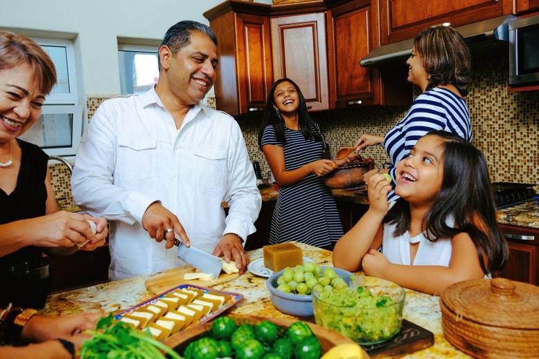 family happily cooking at home