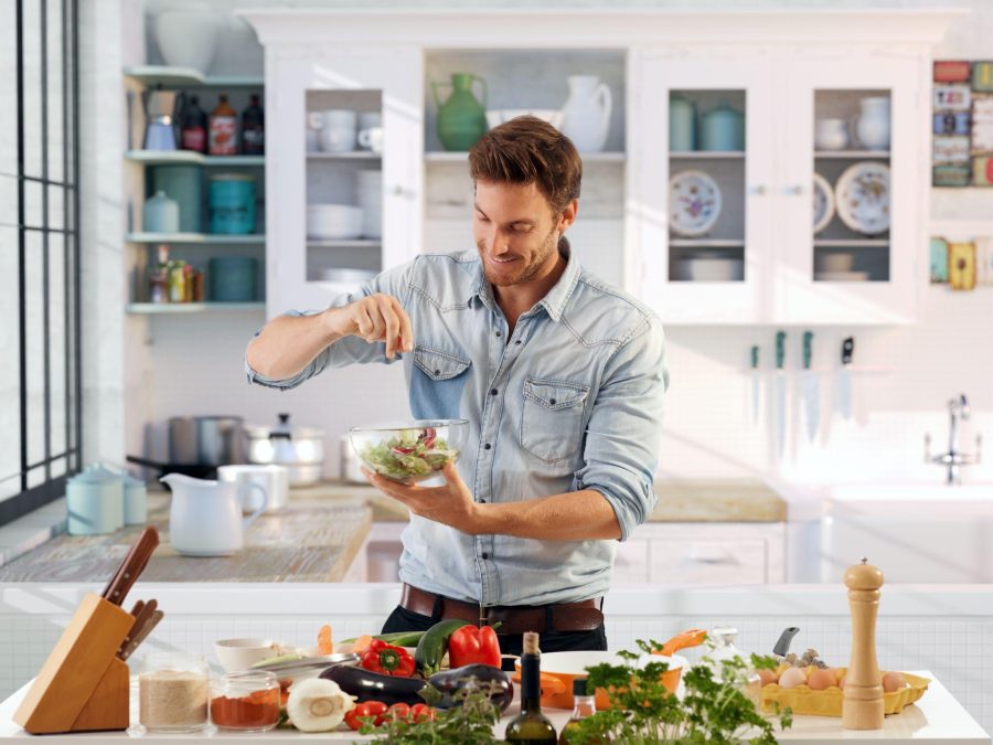 man making a salad at home
