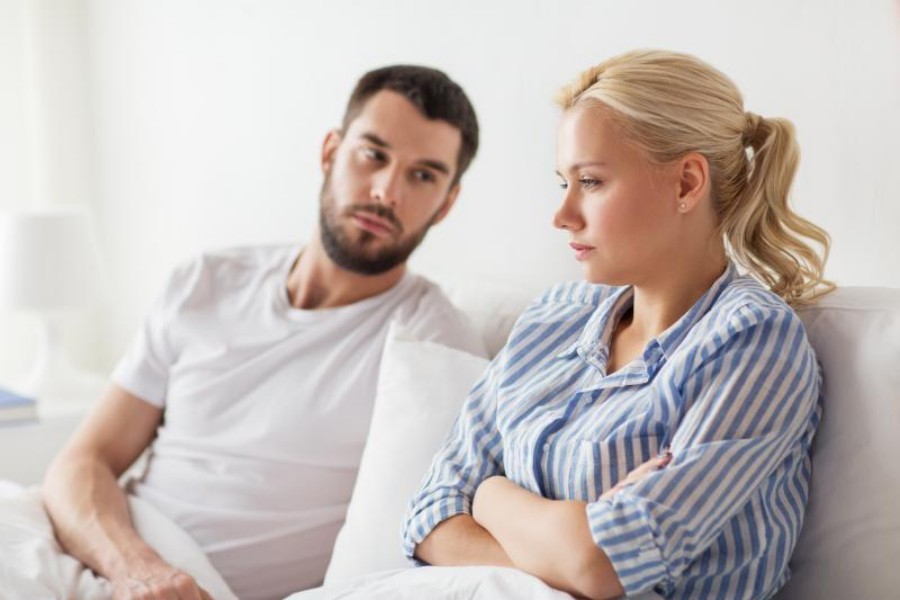 young couple in a disagreement in bed