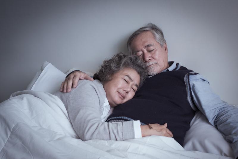 asleep senior couple hugging hugging