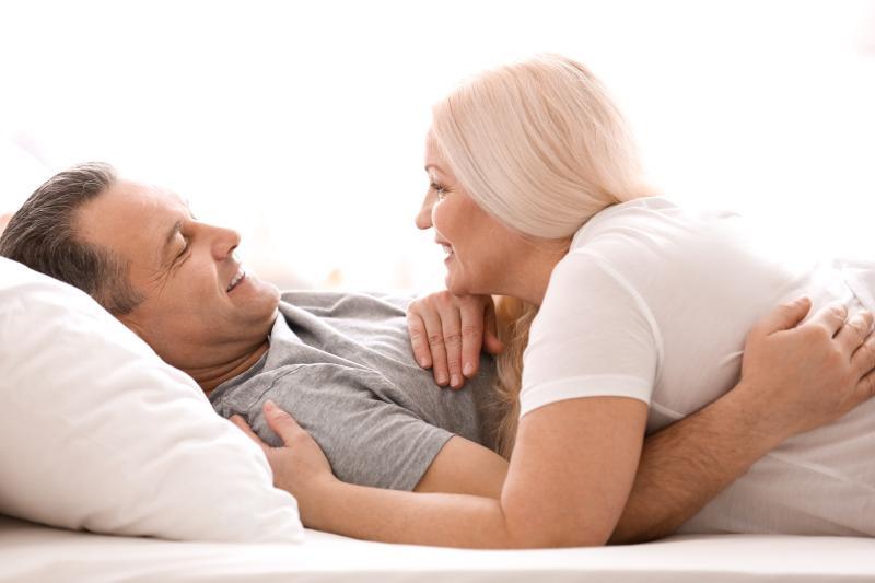 middle-aged couple satisfied in bed