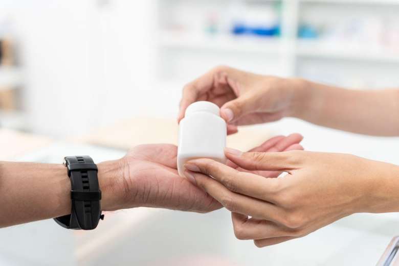 handing medicine to patient