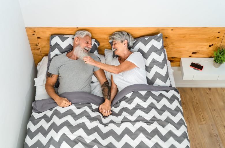 happy elderly couple in bed