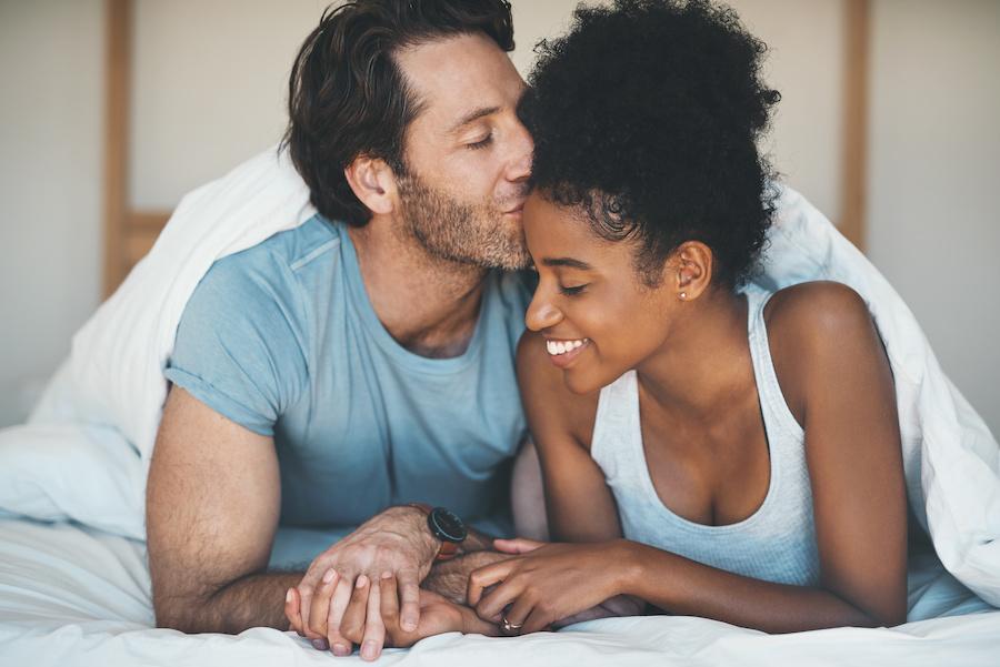 happy young couple in bed