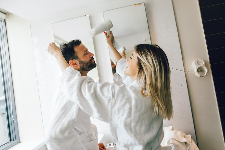 woman drying her boyfriend's hair
