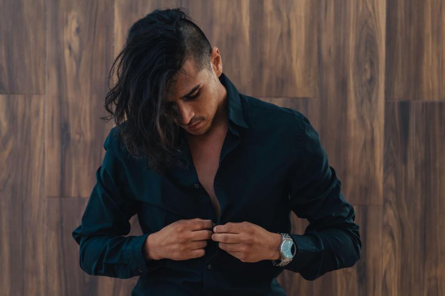 male porn star putting his shirt back on