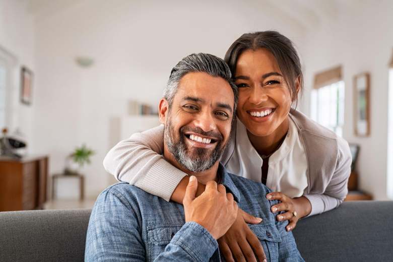 young couple in their home smiling
