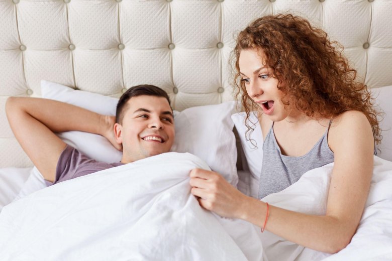 young woman impressed with her partner's penis size