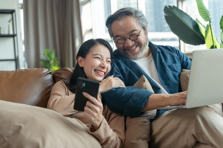 couple sitting in their living room and having a fun conversation