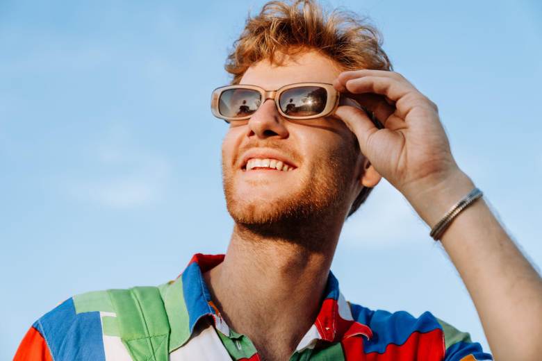 man wearing sunglasses smiling