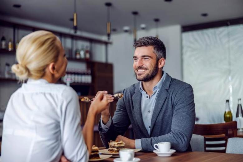 middle aged couple in business atire having breakfast