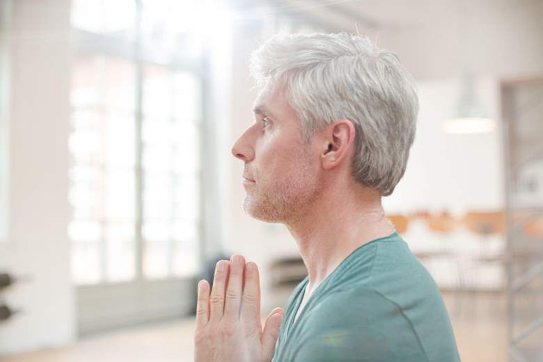 middle-aged man meditating alone