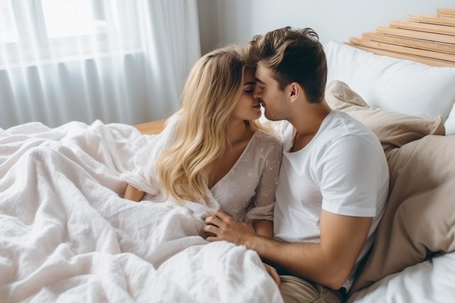 young couple kissing in bed