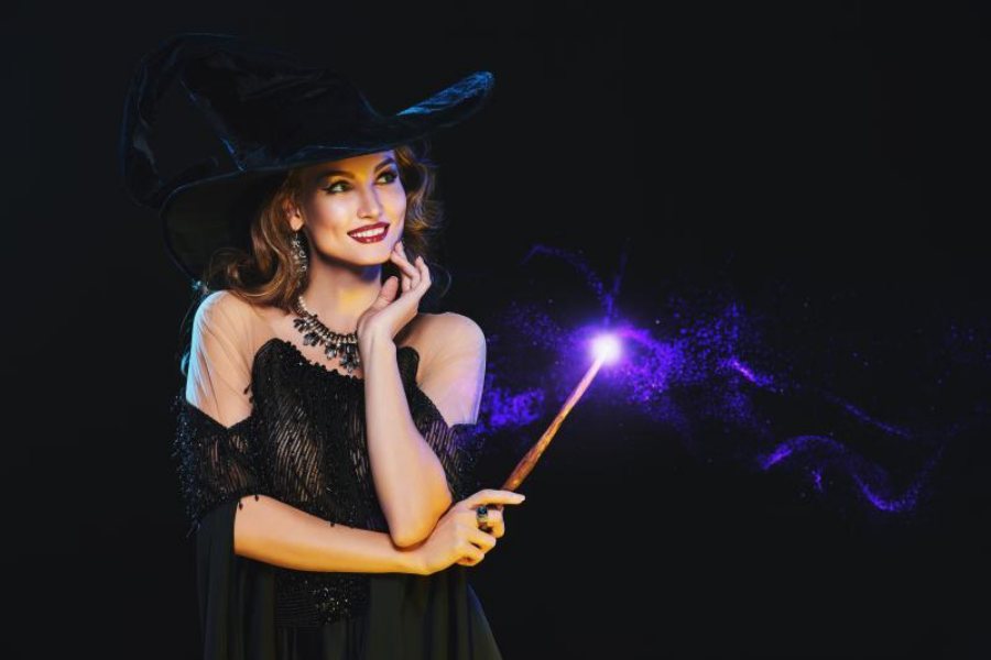 beautiful witch smiling playing a trick