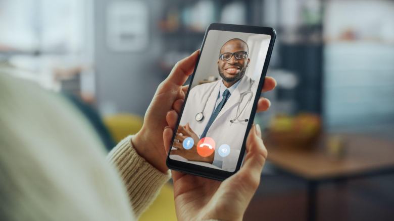 doctor having a video call with a patient on the phone