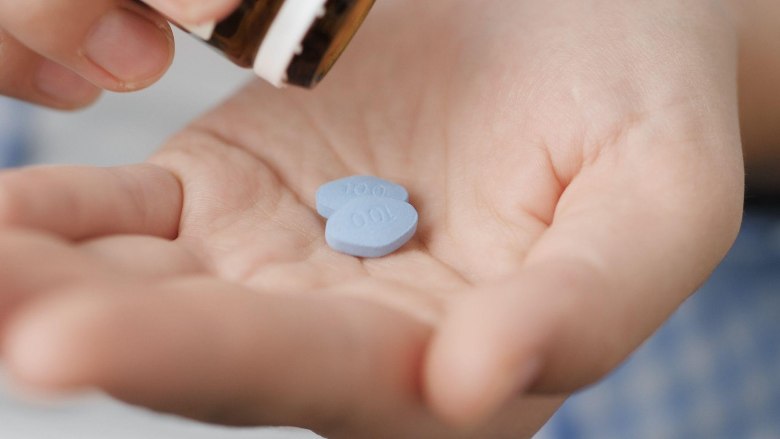 two 100mg viagra pills on a someone's hand